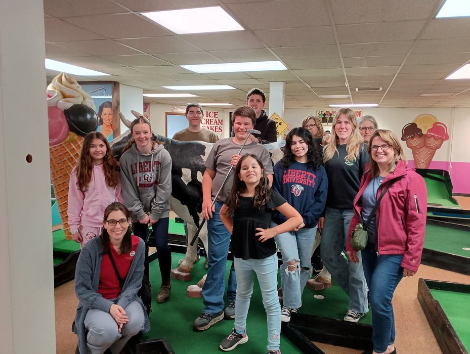 4-H Catawba County Leadership Council members taking a group picture at miniature golf, team building experience.