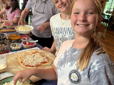 Adding pizza toppings at Pizza Camp