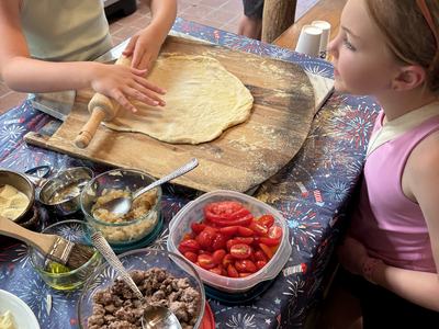 Rolling out the dough to make pizza and Pizza Camp