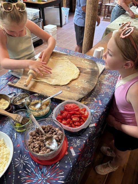 Rolling out the dough to make pizza and Pizza Camp
