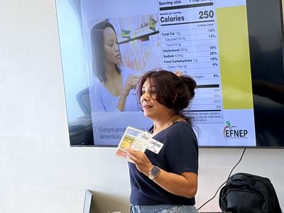 Patty teaching in front of a group using a powerpoint