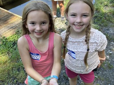 Holding a frog at the fish hatchery
