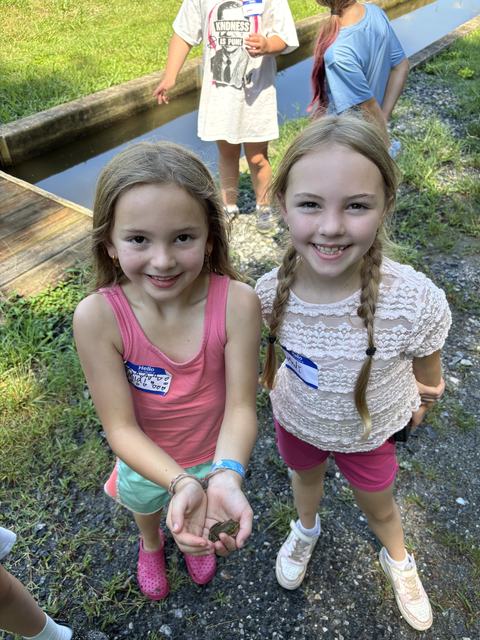 Holding a frog at the fish hatchery