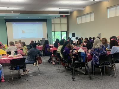 Girls sitting around tables in a conference room