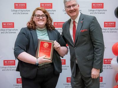 Kristi Willard with award and Dean Fox