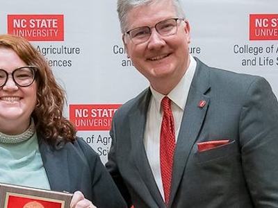 Kristi Willard with award and Dean Fox
