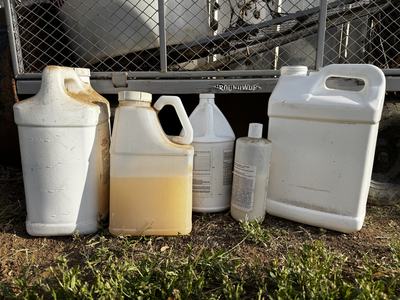 Empty and half-full pesticide containers