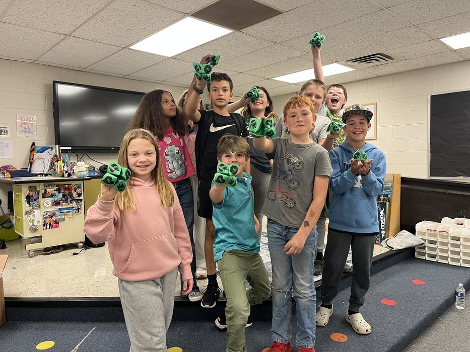 4-H club members posing with a clover catcher craft