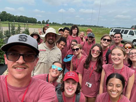 students looking at sweetpotato breeding plots