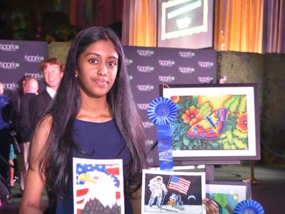Akshita holding her artwork
