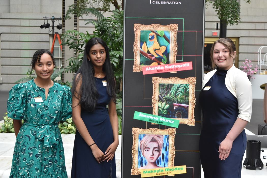 Akshita standing next to her art