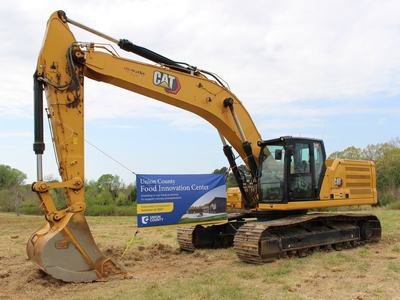 Banner announcing the Union County Food Innovation Center hanging from piece of heavy equipment
