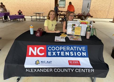 master gardener volunteers attending a festival to promote NC Cooperative Extension