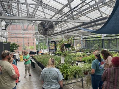 Samantha Byrd teaching group in greenhouse