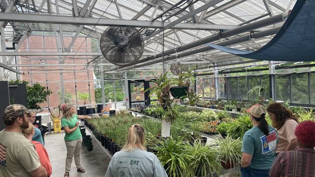 Samantha Byrd teaching group in greenhouse