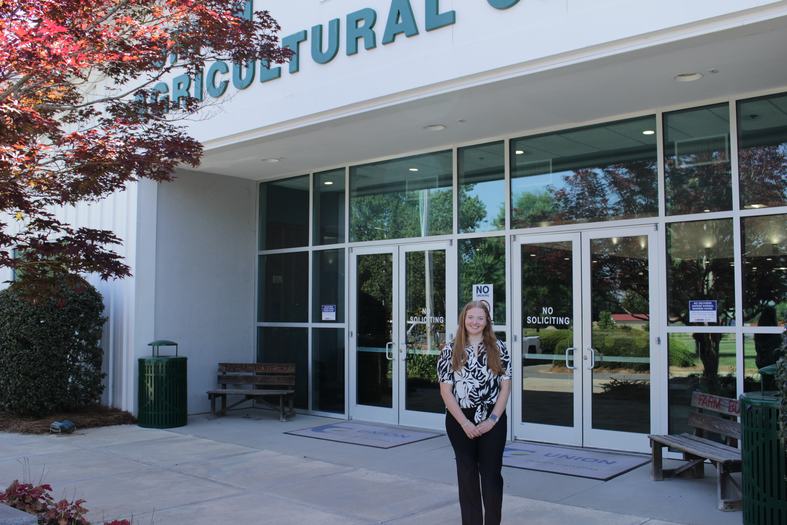 A Union County 4-H summer intern poses outside the Union County Agricultural Center.