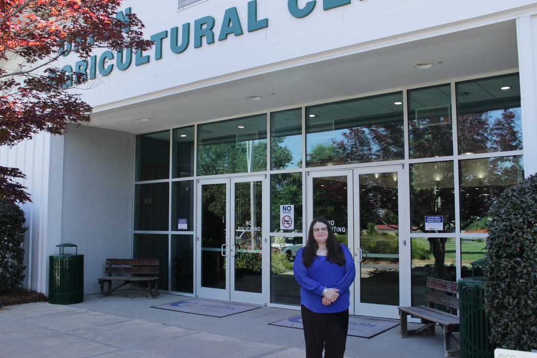 A Union County 4-H summer intern poses outside the Union County Agricultural Center.
