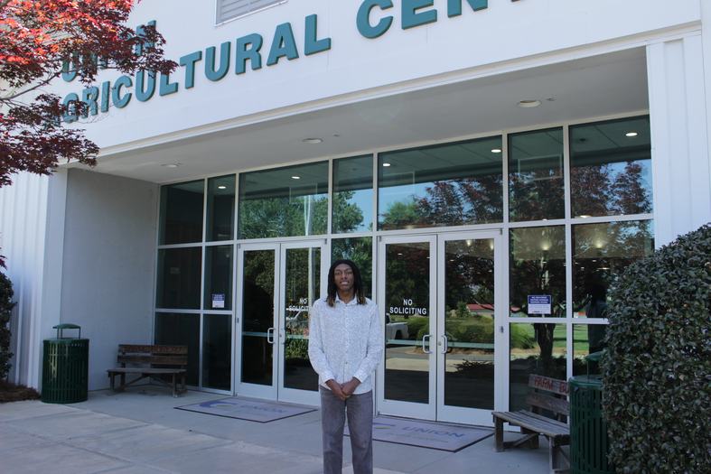 A Union County 4-H summer intern poses outside the Union County Agricultural Center.