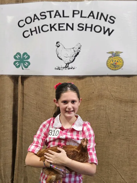 girl holding chicken
