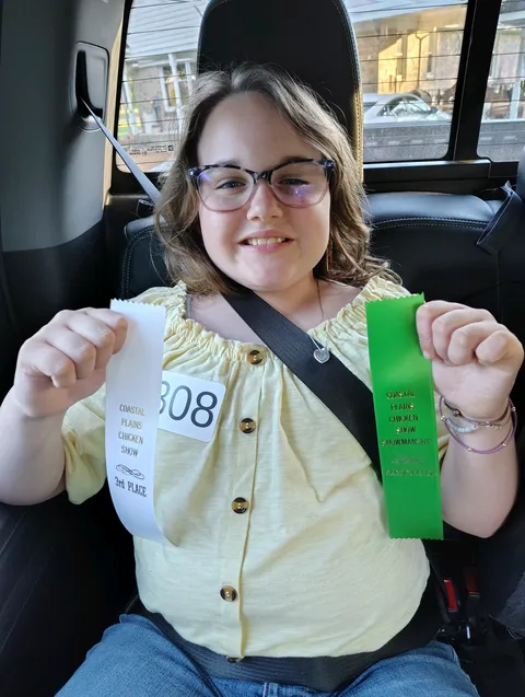 girl showing off ribbons