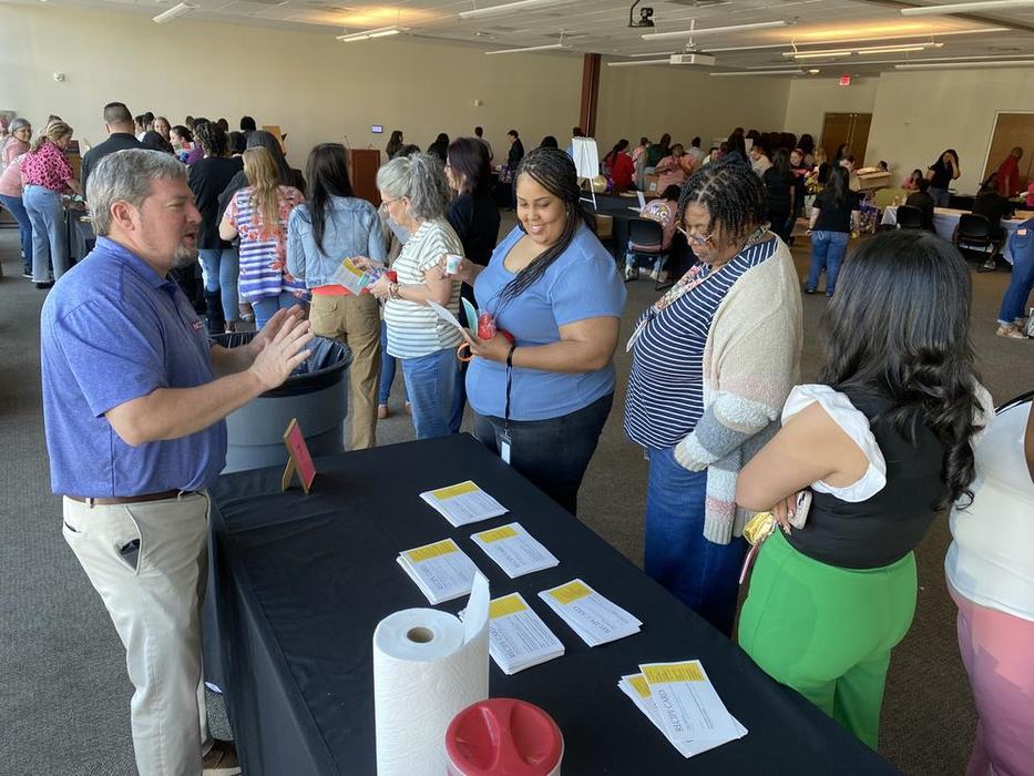 Extension agent talking to people at a health fair