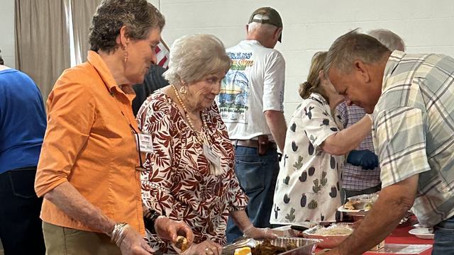 Servers fill up the plates at the Wild Foods Cook Off