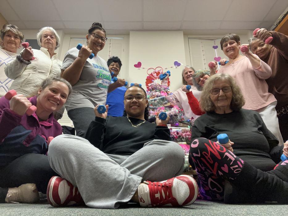 Group of people holding weights