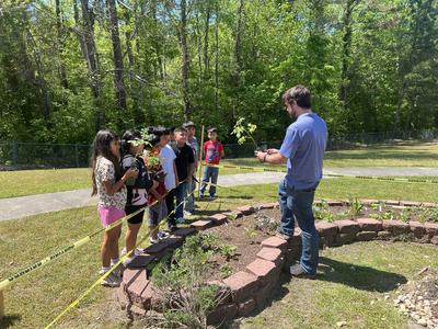Extension Agents collaborating with schools to teach planting, growing and eating.