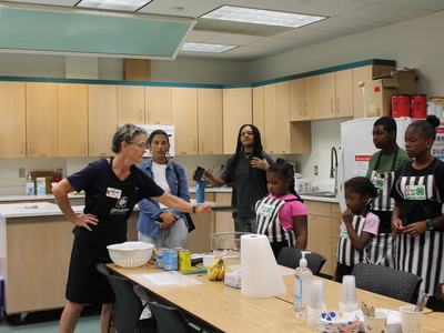 EFNEP educator is giving the preparation lesson to campers.