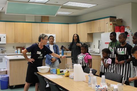 EFNEP educator is giving the preparation lesson to campers.