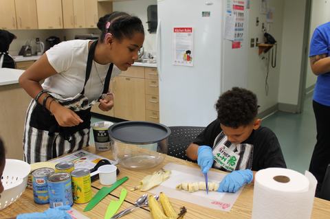 Campers are cutting up bananas for a smoothie.