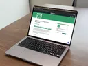 The online project record system displayed on a laptop showing the North Carolina 4-H project record Kaleidoscope homepage.
