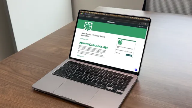 The online project record system displayed on a laptop showing the North Carolina 4-H project record Kaleidoscope homepage.