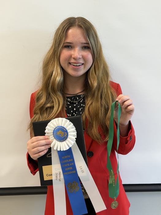 Karleigh Meads- 14-18 Public Speaking Champion with her first place ribbon, medal and padfolio.
