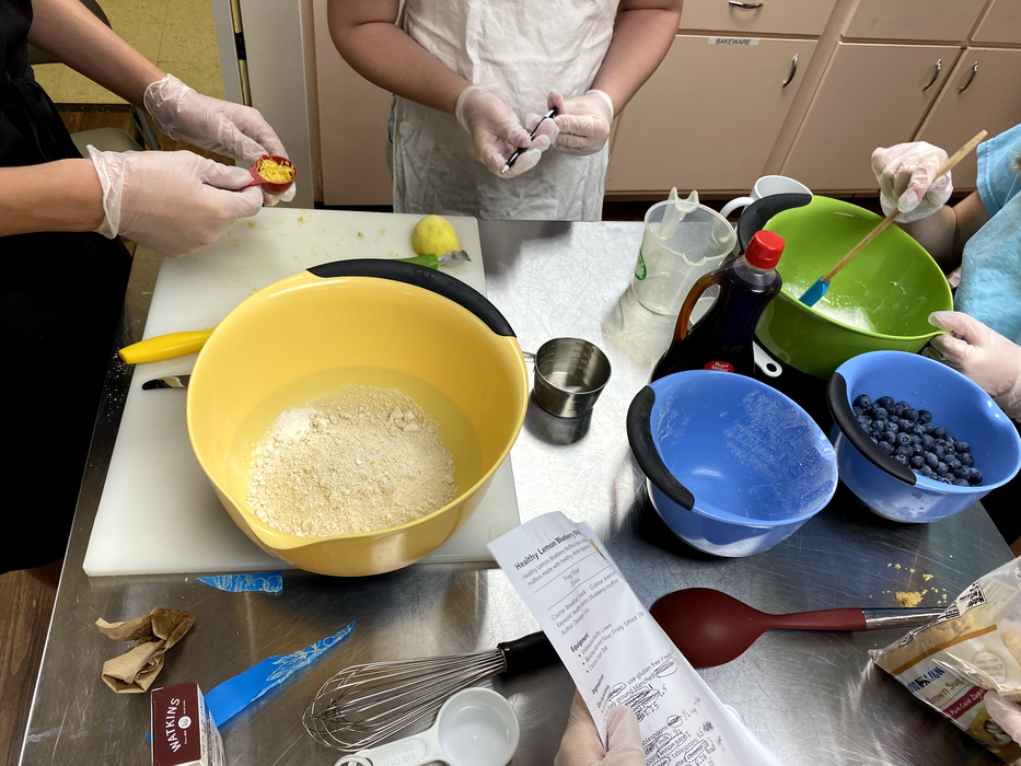Youth assemble the ingredients needed to make lemon blueberry muffins from scratch.