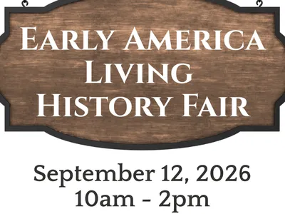 wooden hanging sign advertising the Early America Living History Fair
