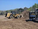 Loading Composted Mulch generated from storm debris into a dump truck