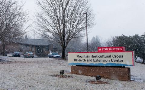 Mountain Horticultural Crops Research and Extension Center sign and building in snow