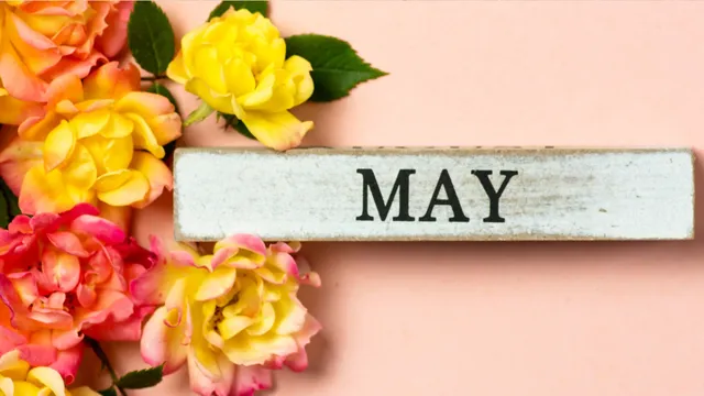 flowers next to block that reads May for decoration
