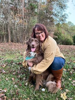 Valery Miller posing her dog.