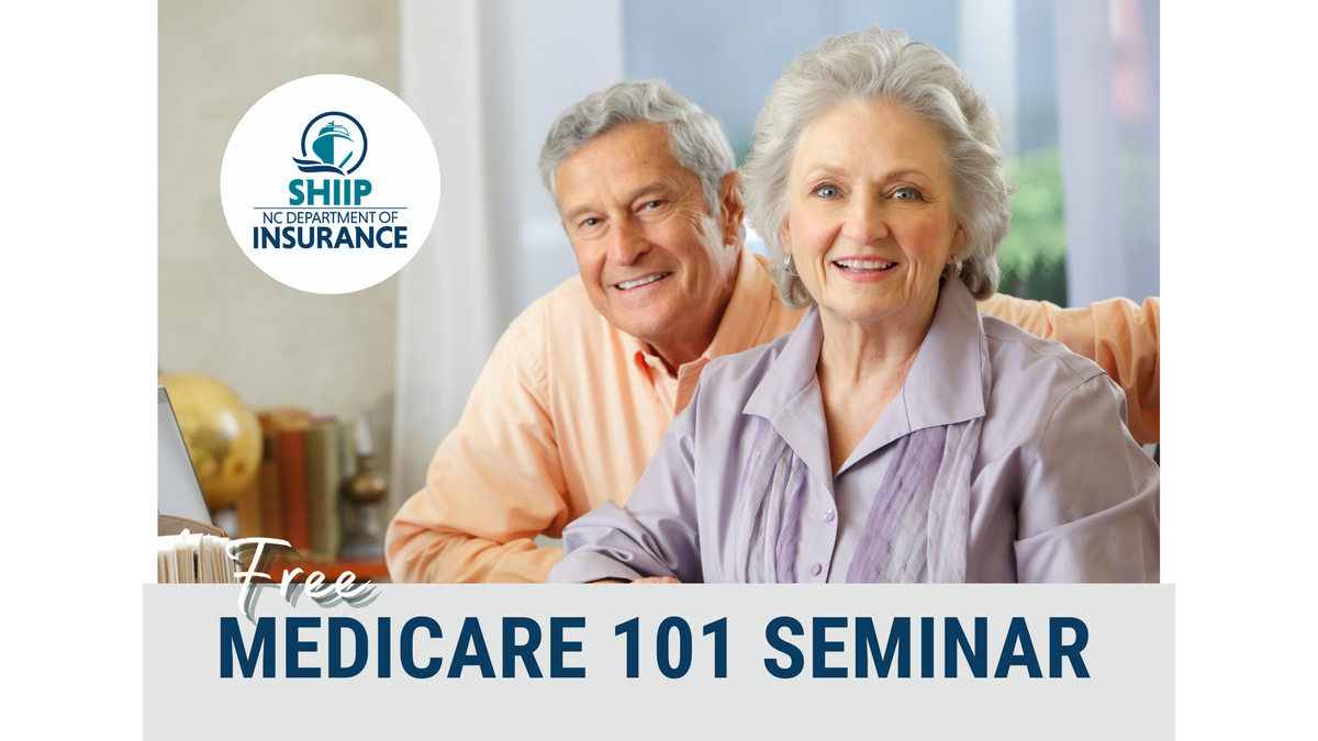 Older couple at computer desk smiling for camera