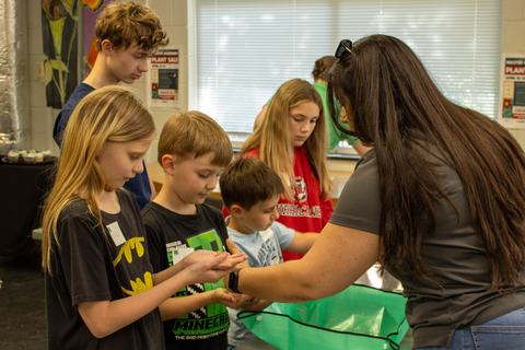 Youth learning how to sow seeds