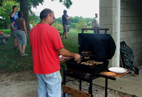 Person grilling food outdoors