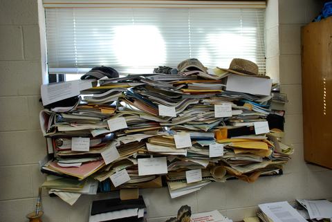 Pile of papers stacked in office window