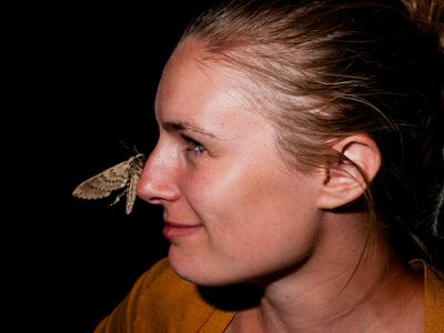 Person with moth on nose