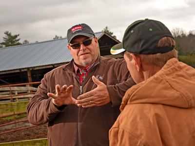 Damon Pollard talking to a producer in the field.