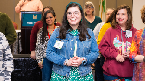 A 4-H volunteer holds a candle to signify her induction as a North Carolina 4-H Volunteer Leaders' Association Officer.