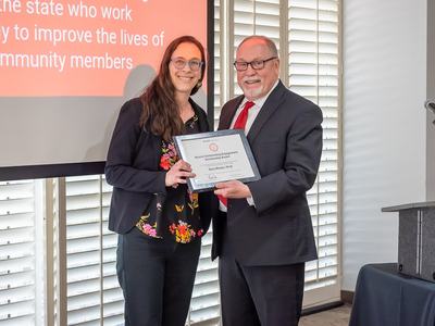Dr. Dara Bloom receiving an award from Dr. David Monks at the NCSU Outreach and Engagement Awards Ceremony