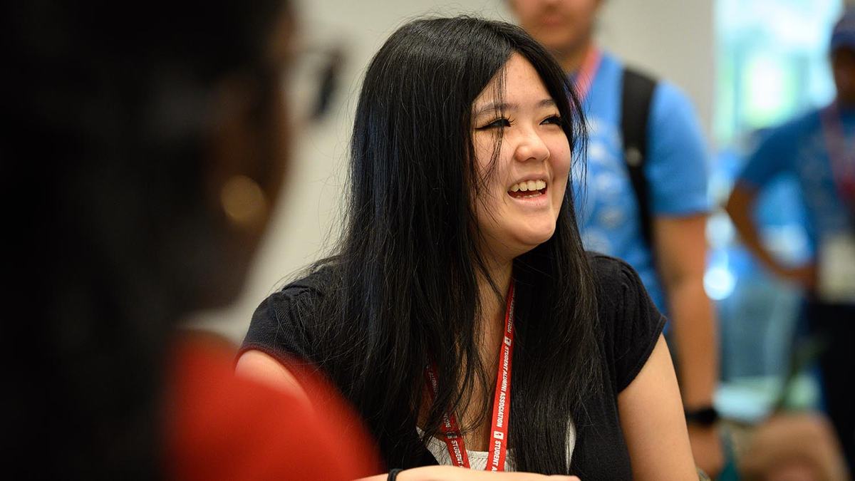 A teenager sits at a table