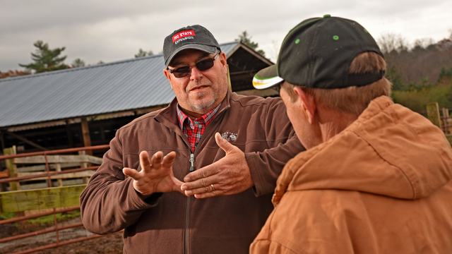 Damon Pollard talking to a producer in the field.